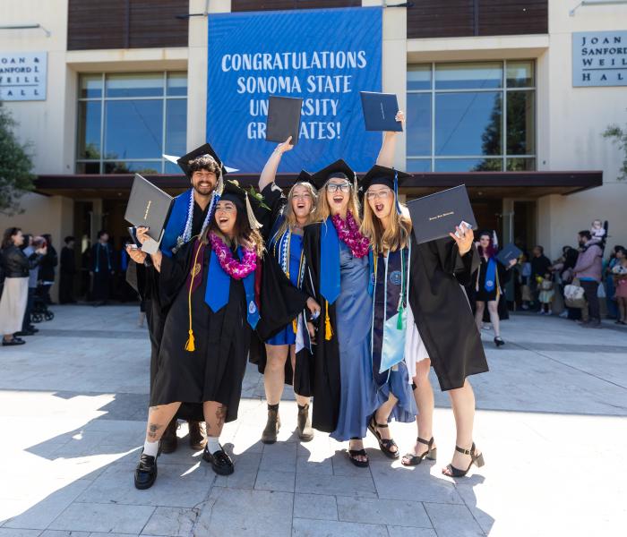 Graduates cheering outside weill hall