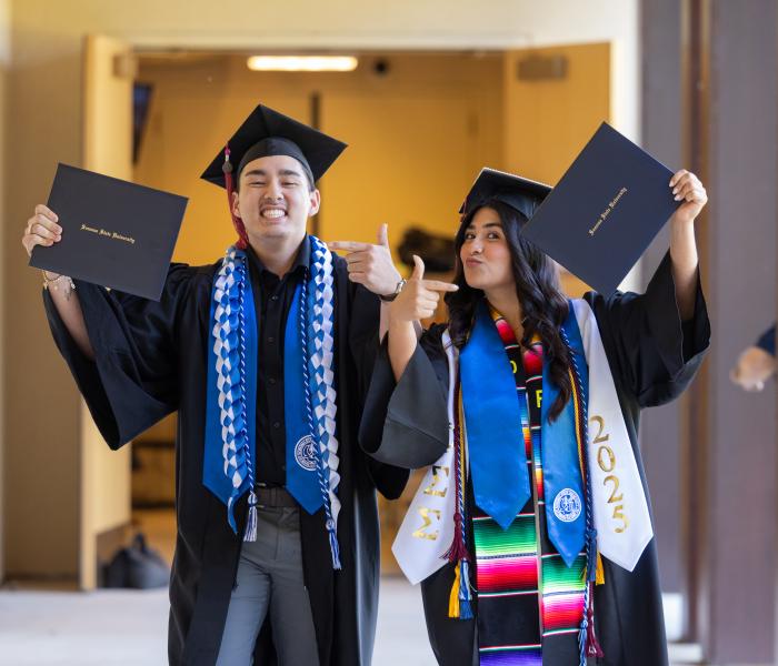 Students showing their diplomas