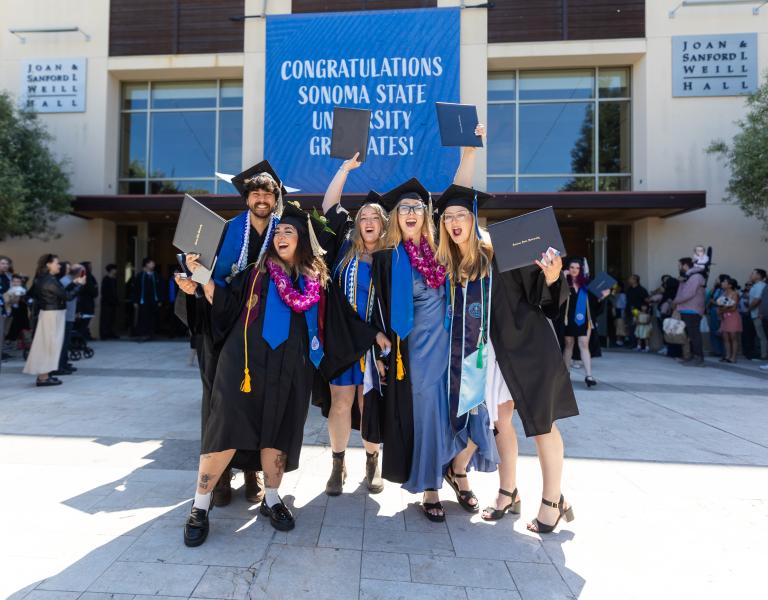 Graduates cheering outside weill hall