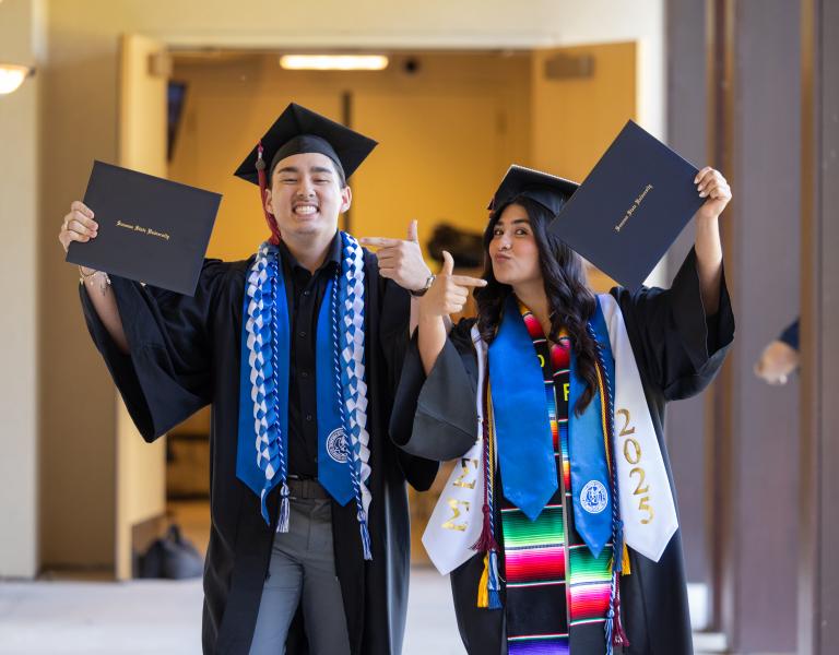 Students showing their diplomas
