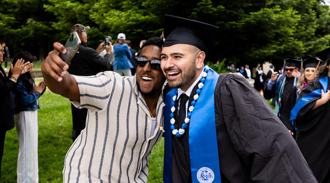 Graduate and friend take selfie