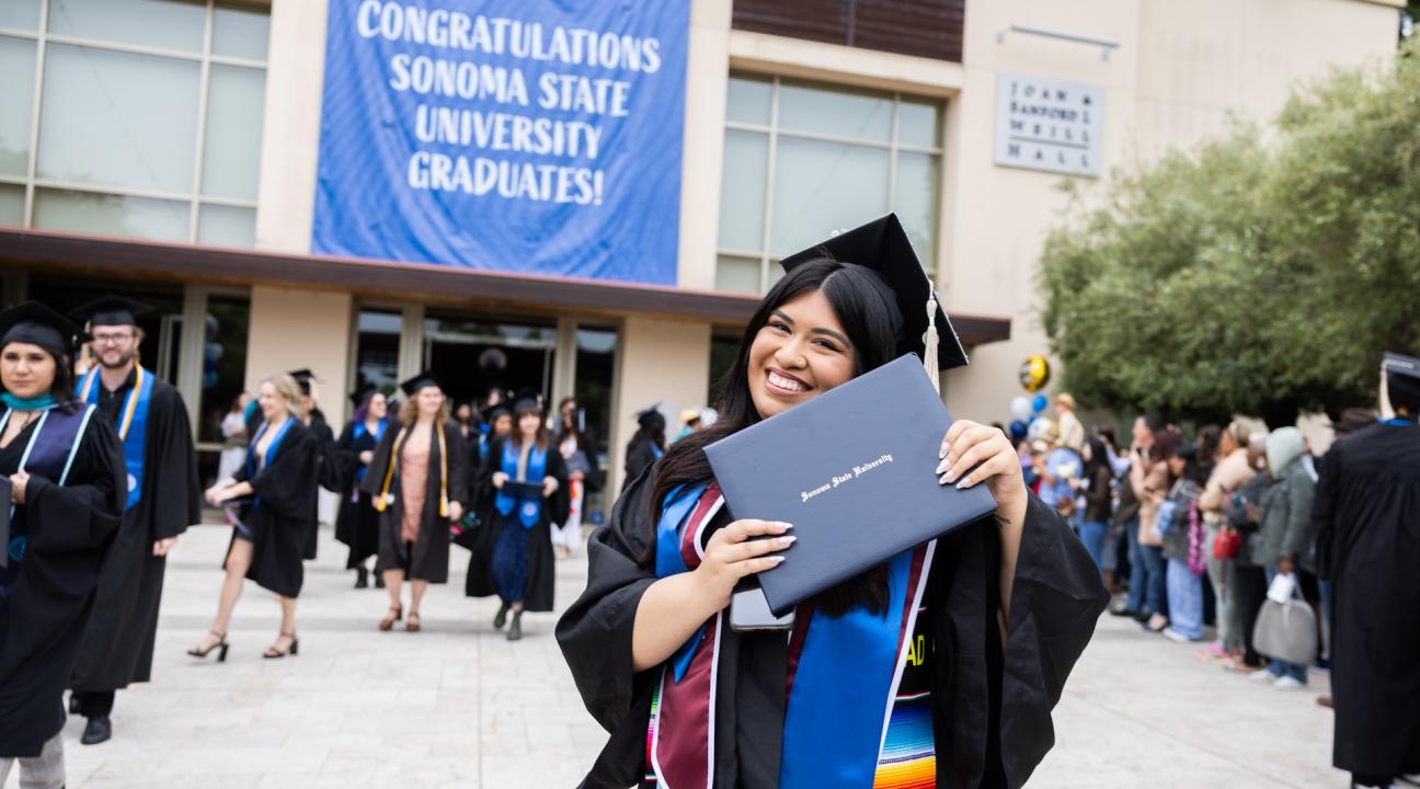 Grad with diploma outside GMC
