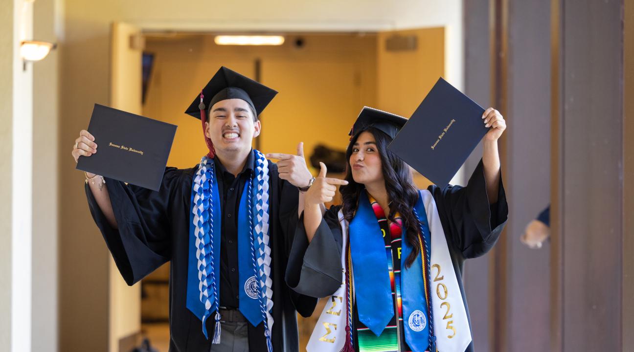 Students showing their diplomas