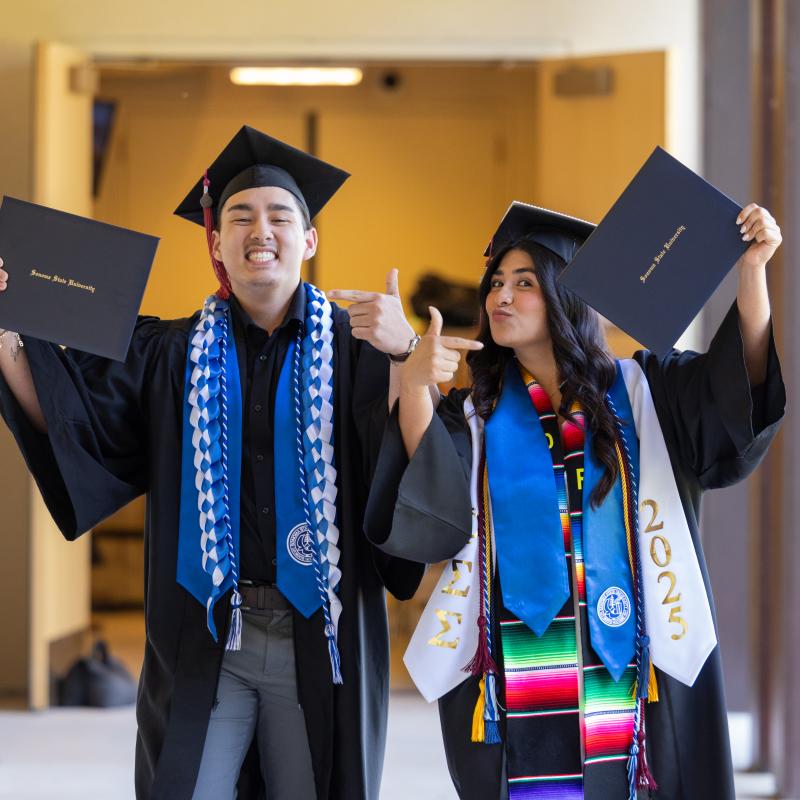 Students showing their diplomas