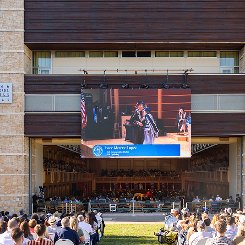 The view of SSU commencement from the lawn seating area into Weill Hall