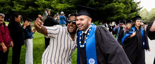 Graduate and friend take selfie
