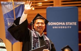 Graduate waving