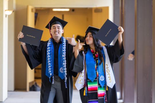 Students showing their diplomas