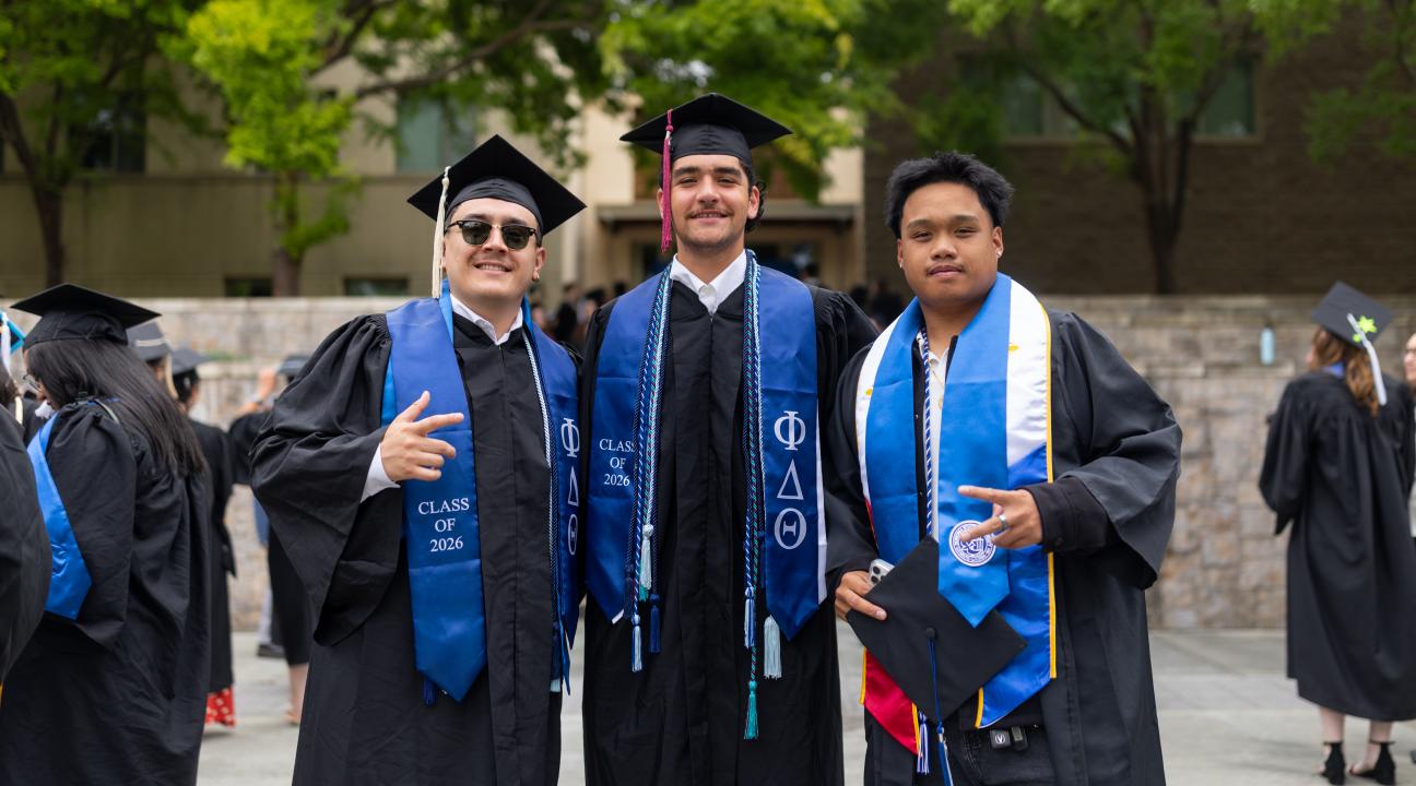 graduates posing together
