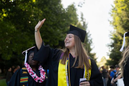 student waving