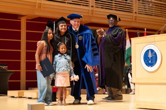 Student and Family on stage